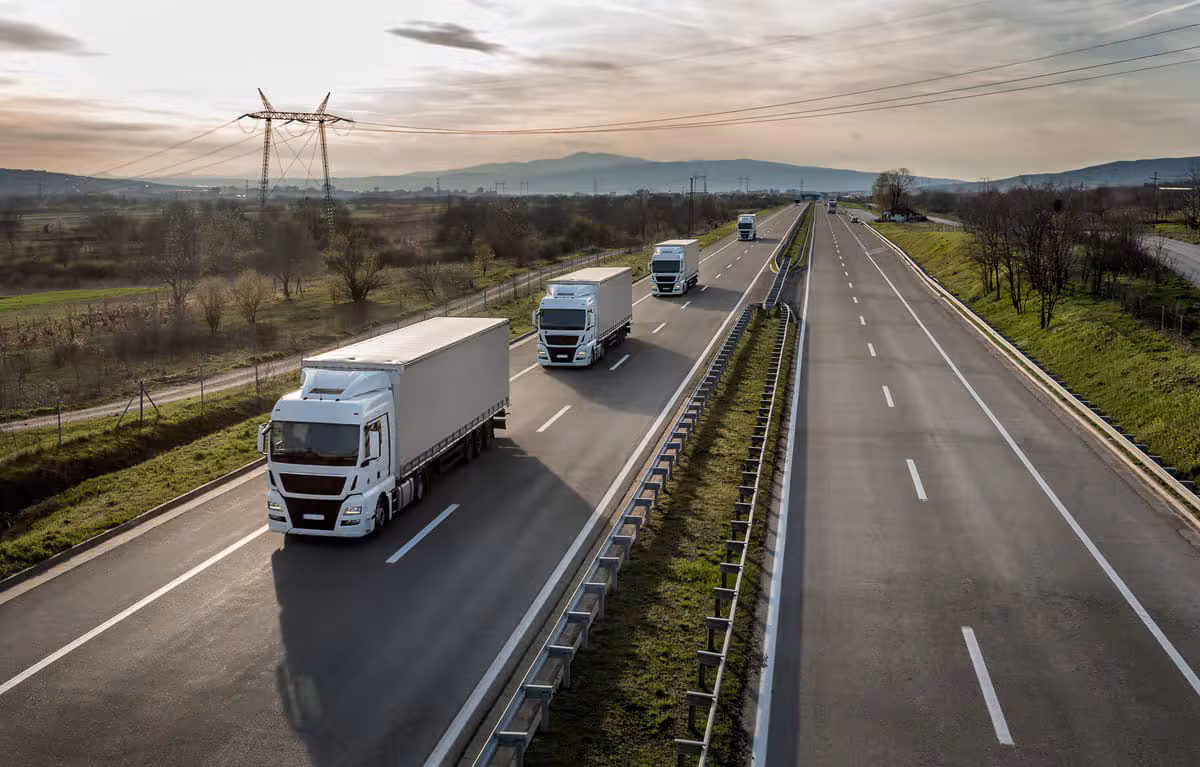 Trucks travelling on a highway — cross-border freight forwarding